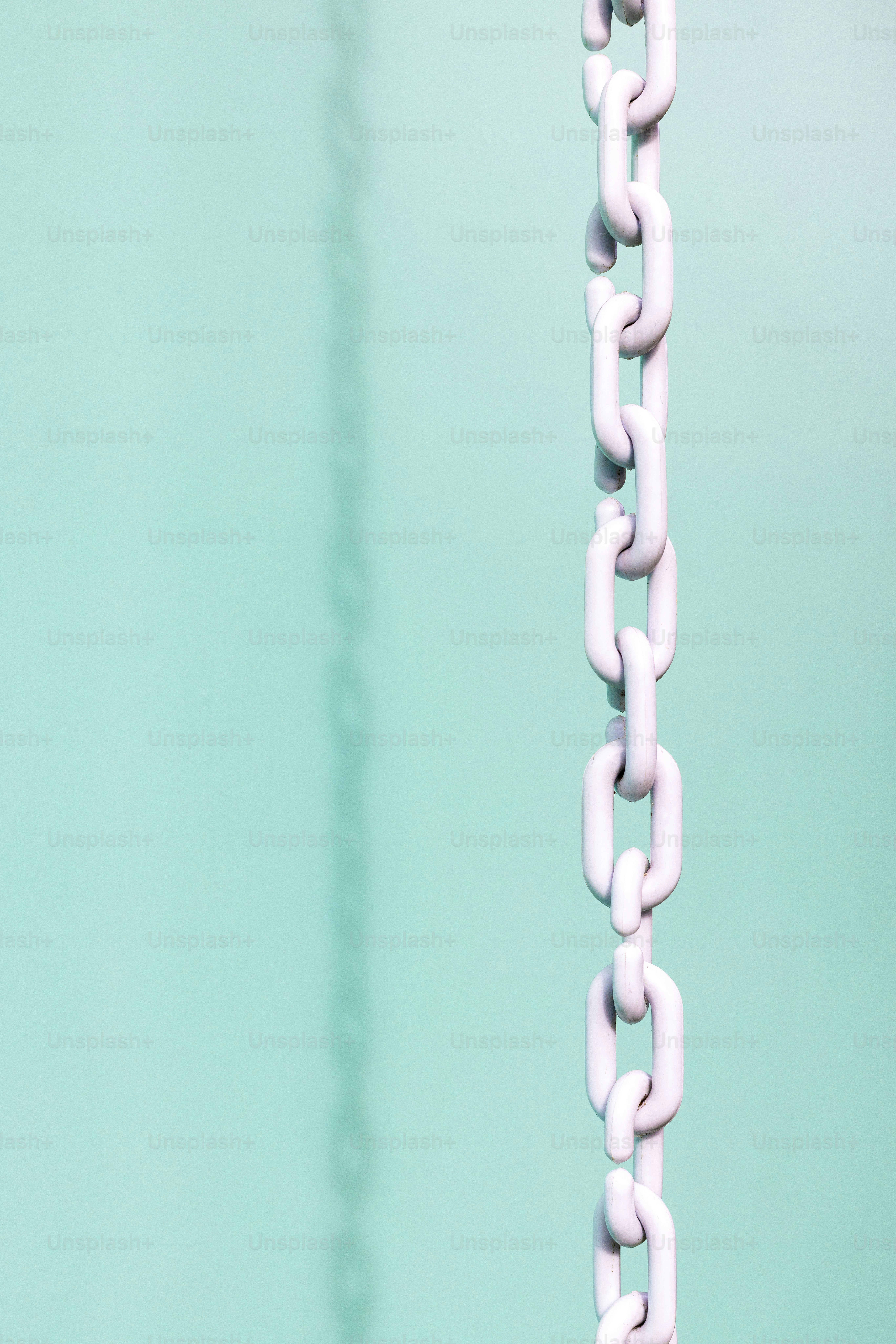 a close up of a white chain hanging from a hook