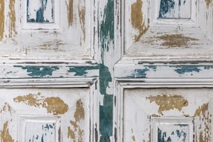 a close up of a door with peeling paint