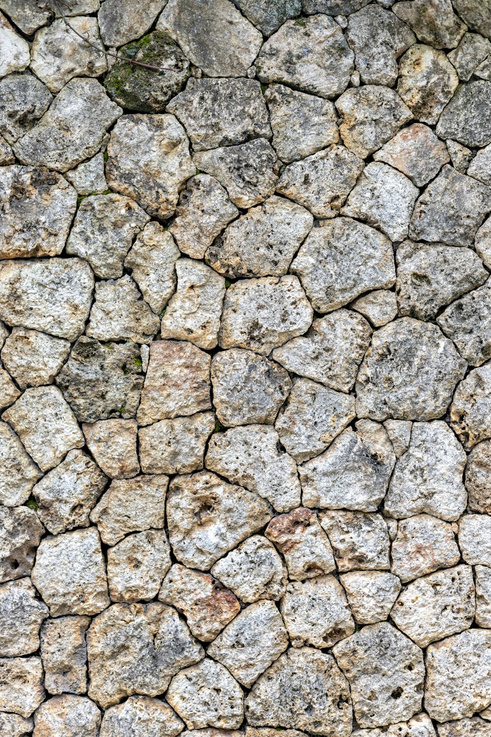 a close up of a stone wall with small rocks