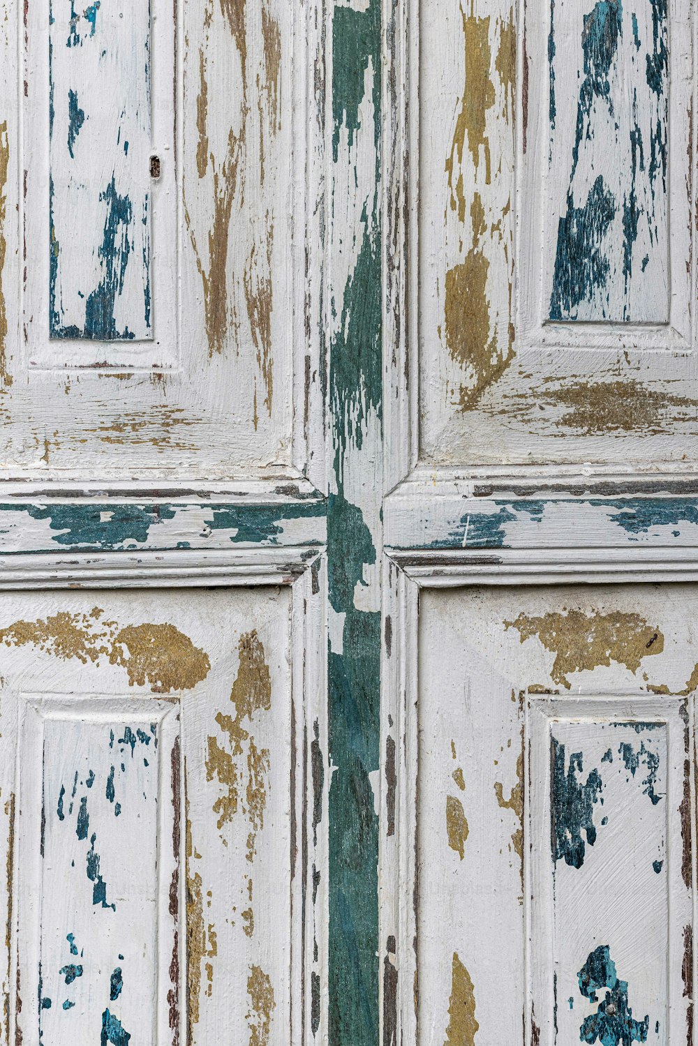 a close up of a door with peeling paint