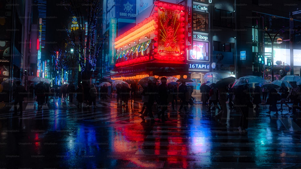 a group of people walking down a street at night