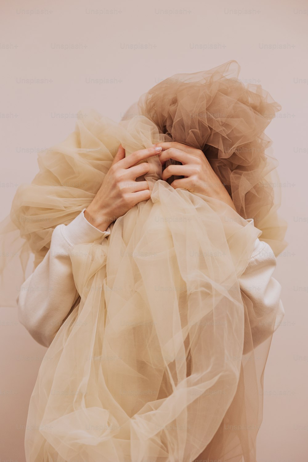 a woman with her hands on her back wrapped in a veil