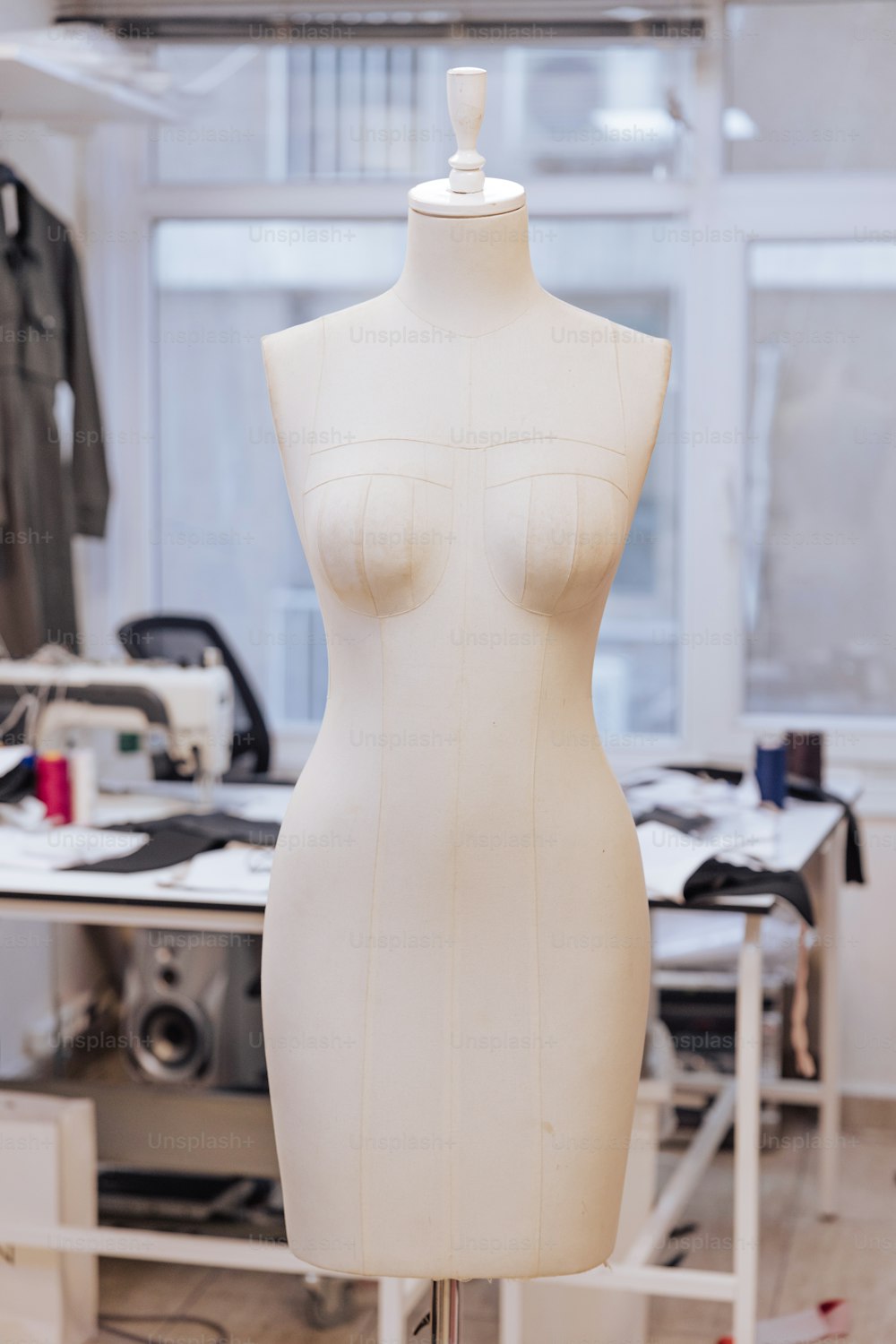 a white mannequin is on a stand in a room