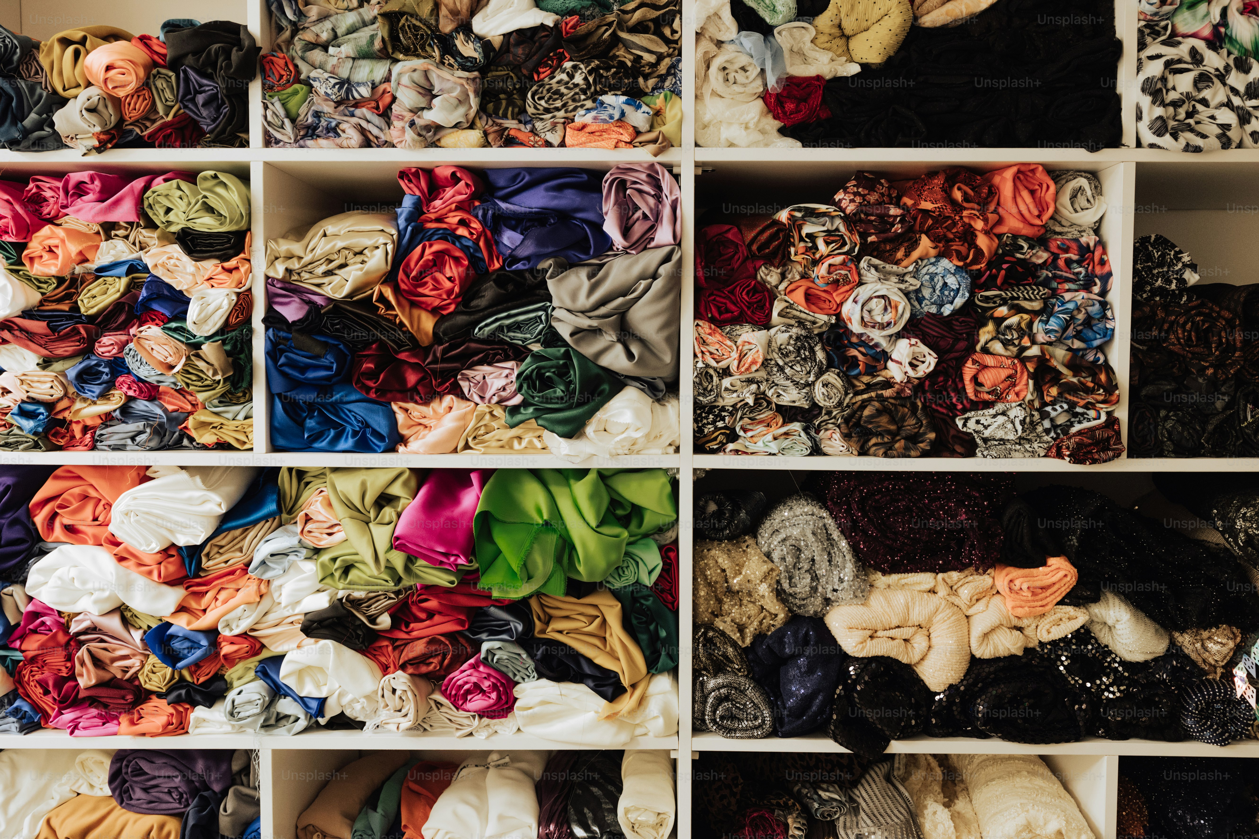 a closet filled with lots of different types of scarves