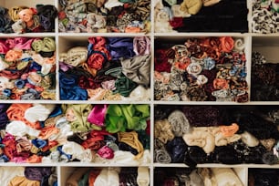 a closet filled with lots of different types of scarves