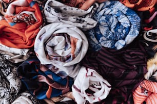 a pile of scarves laying on top of each other