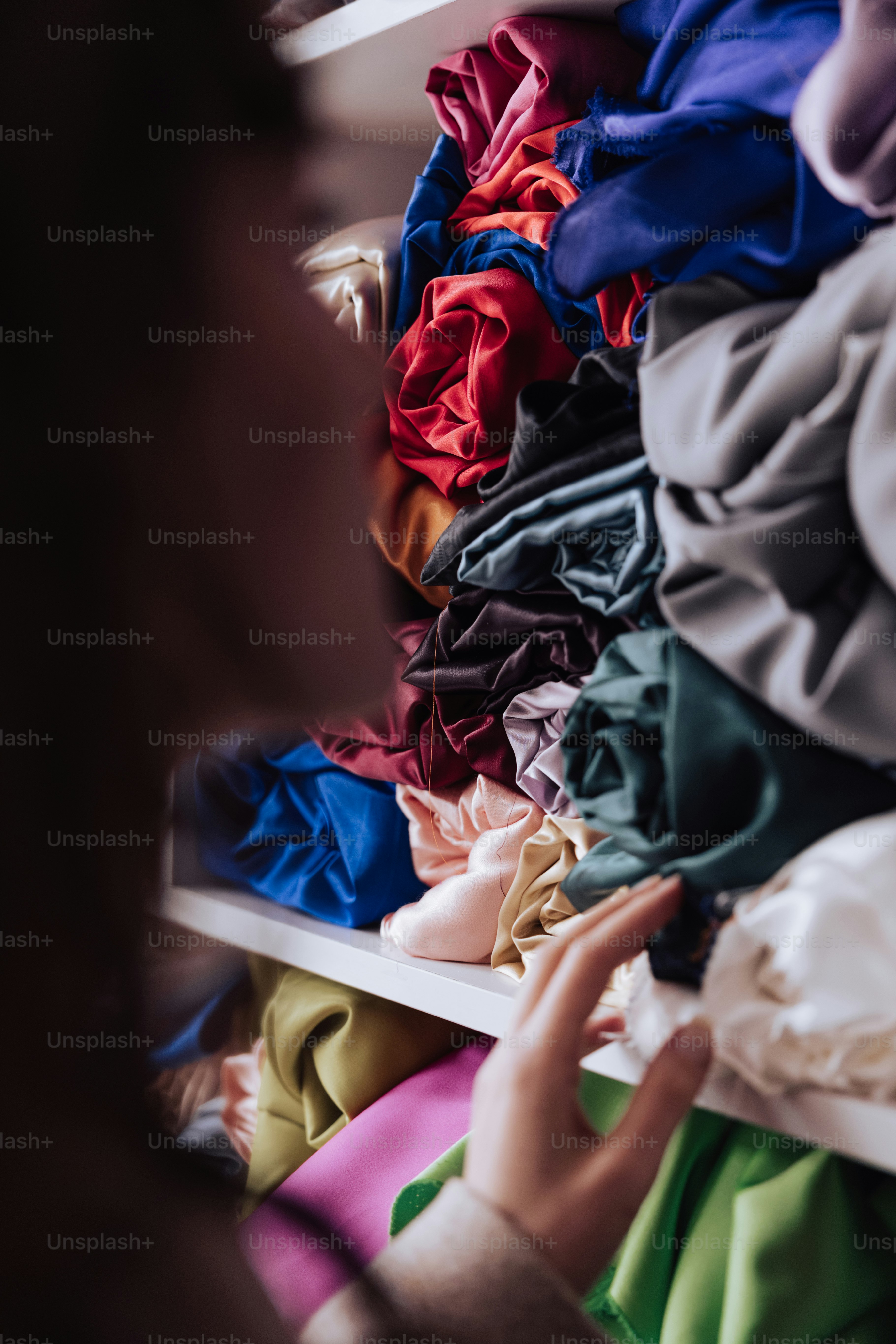 Una mujer está mirando un estante de ropa