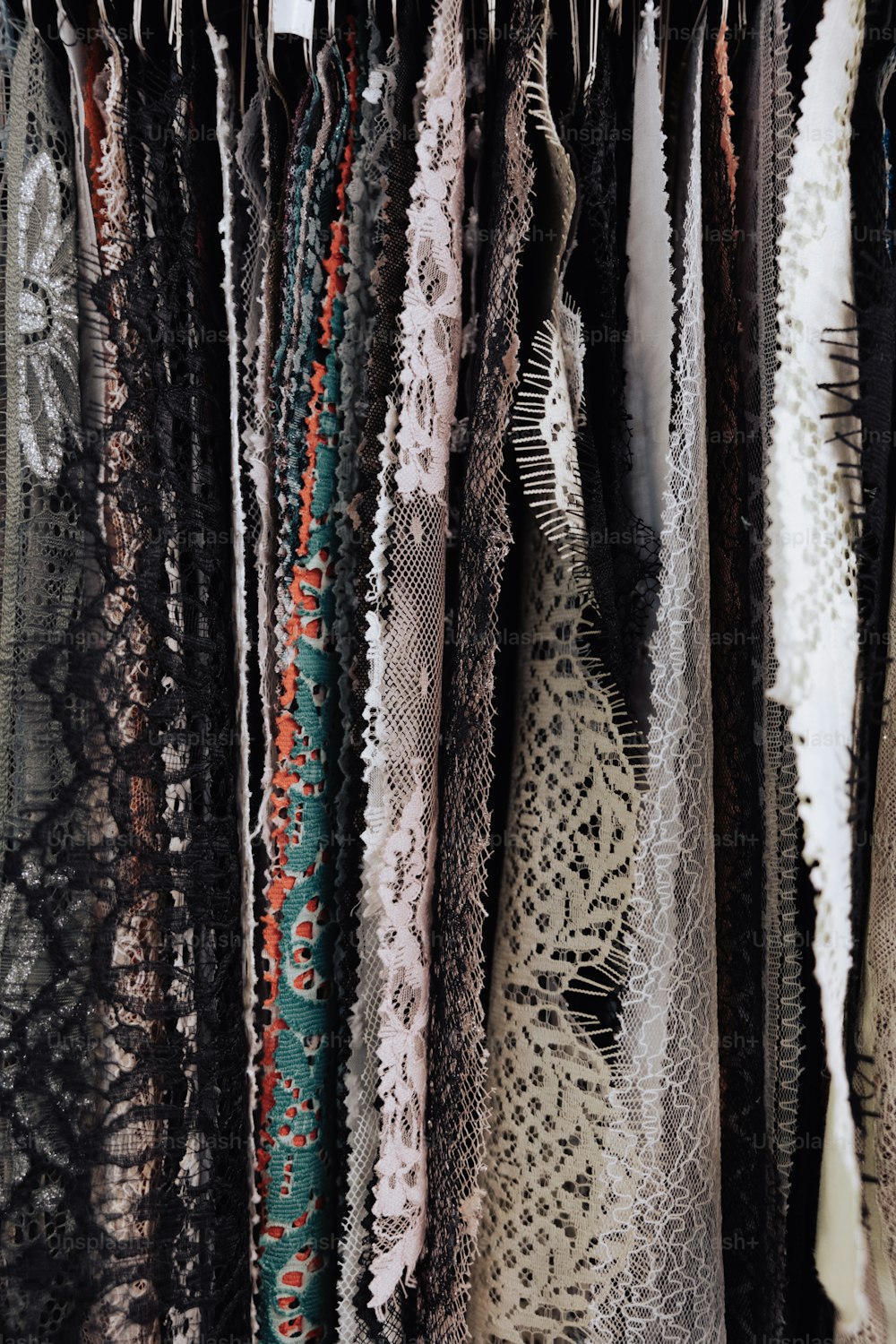 a close up of a rack of scarves