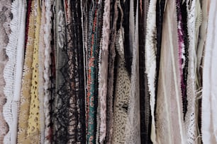 a bunch of scarves are hanging on a rack