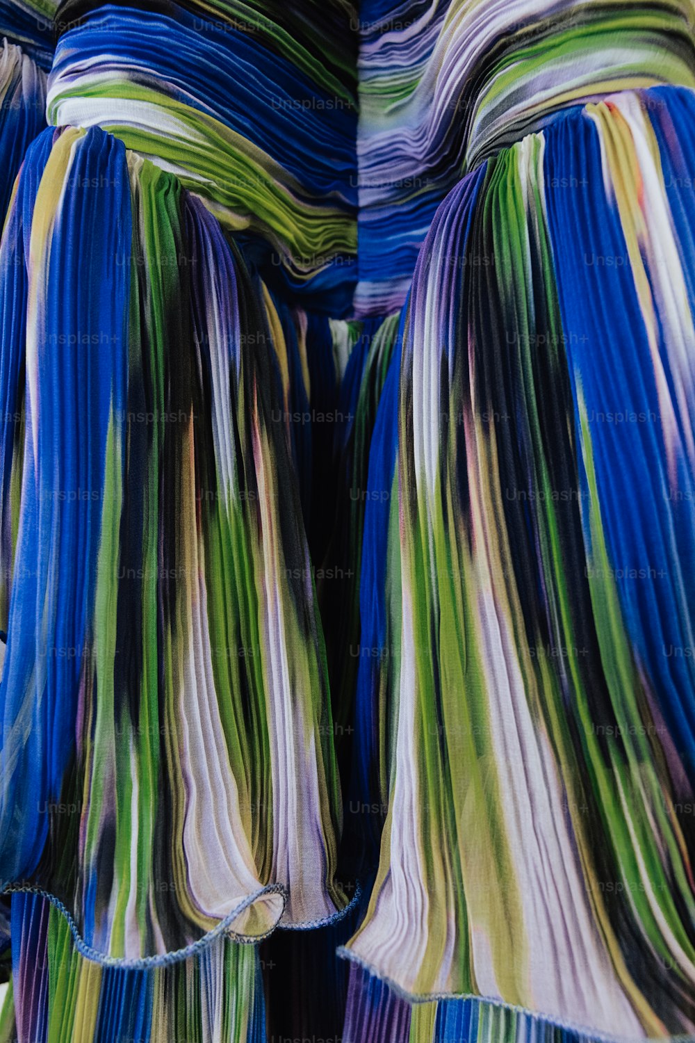 a close up of a colorful dress with a tie