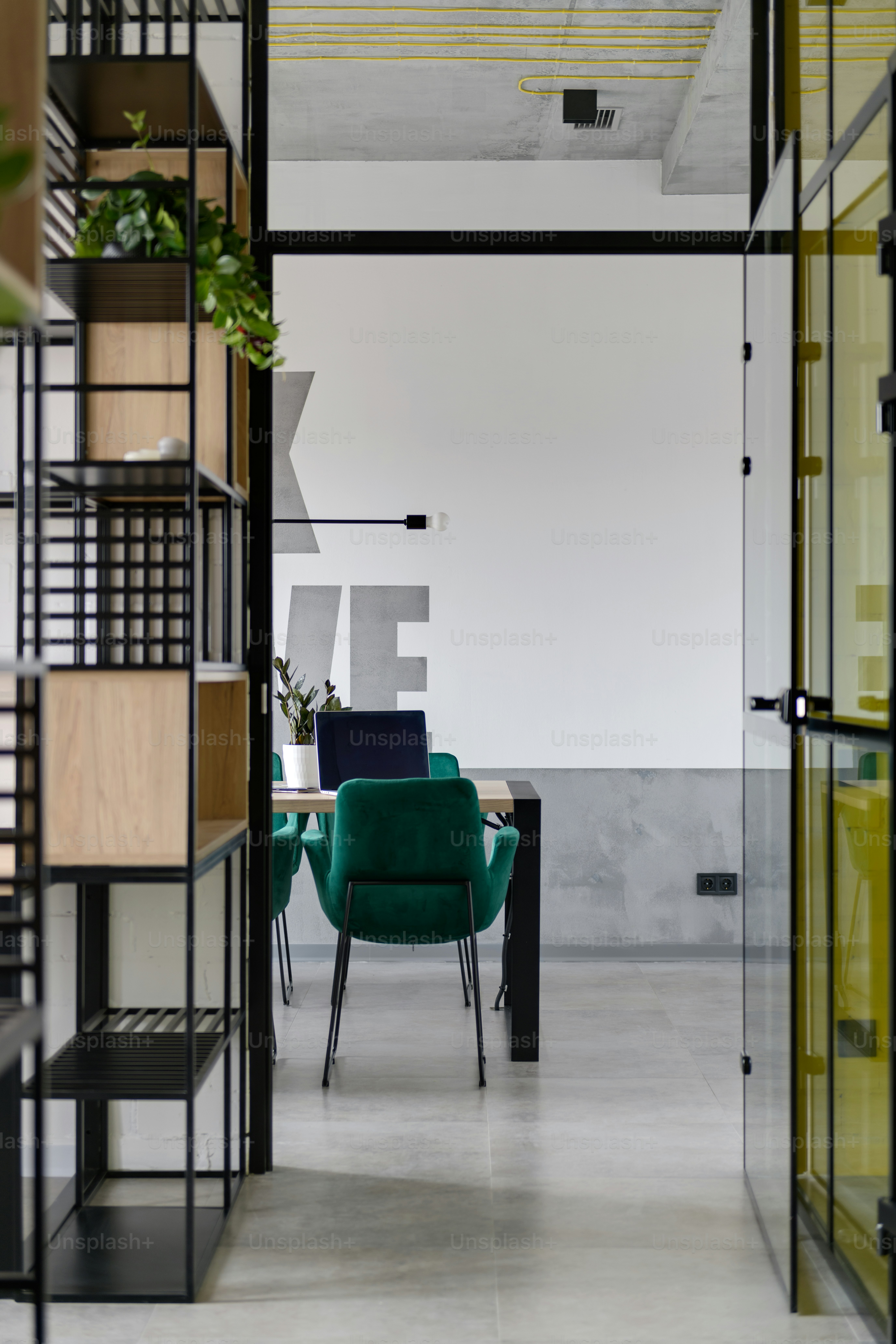 a green chair sitting in a room next to a table