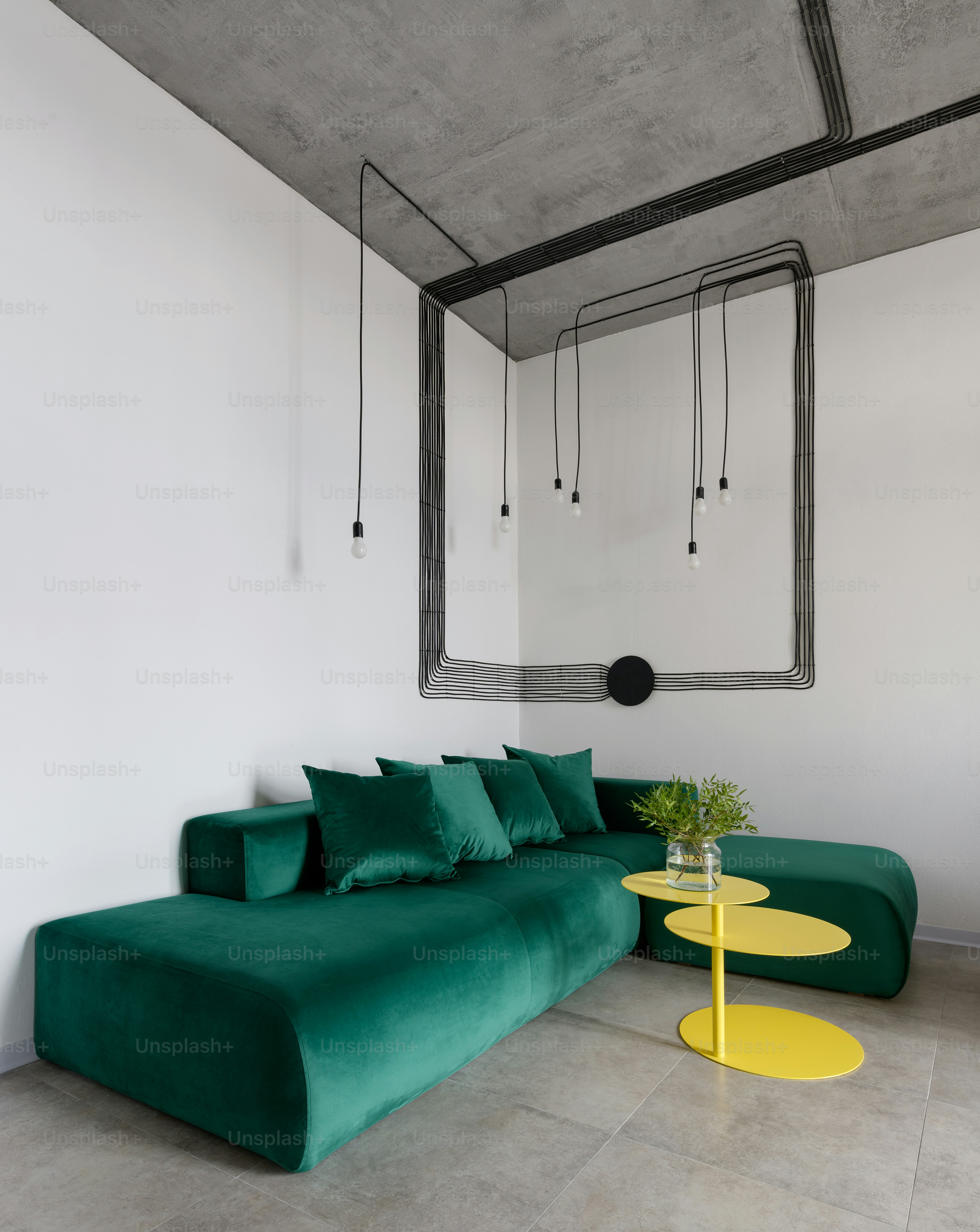 a living room with a green couch and a yellow table