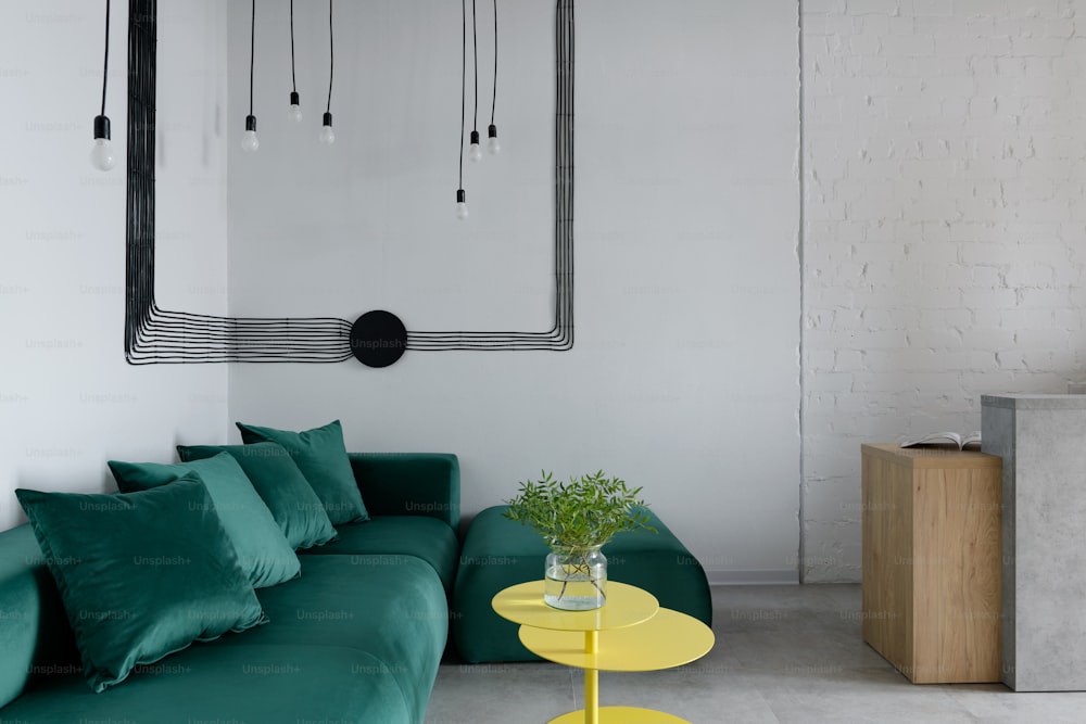 a living room with a green couch and a yellow table