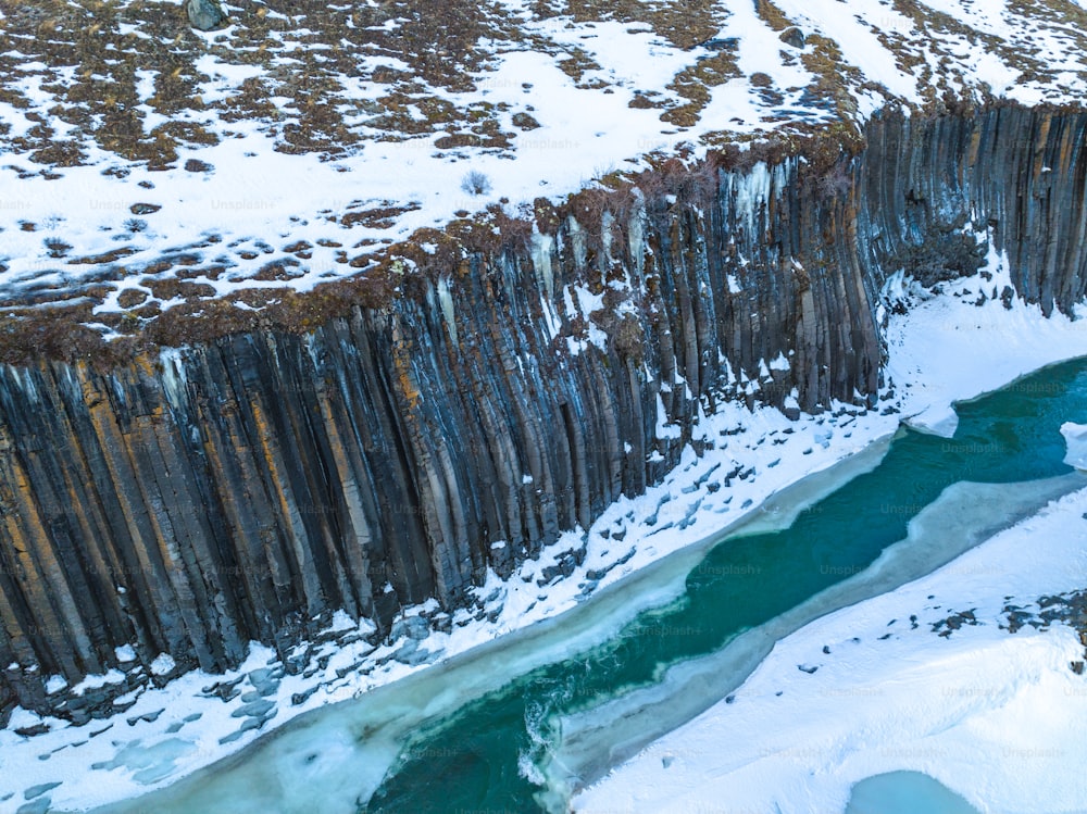 an aerial view of a river and a cliff