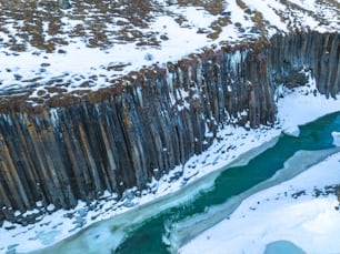 an aerial view of a river and a cliff