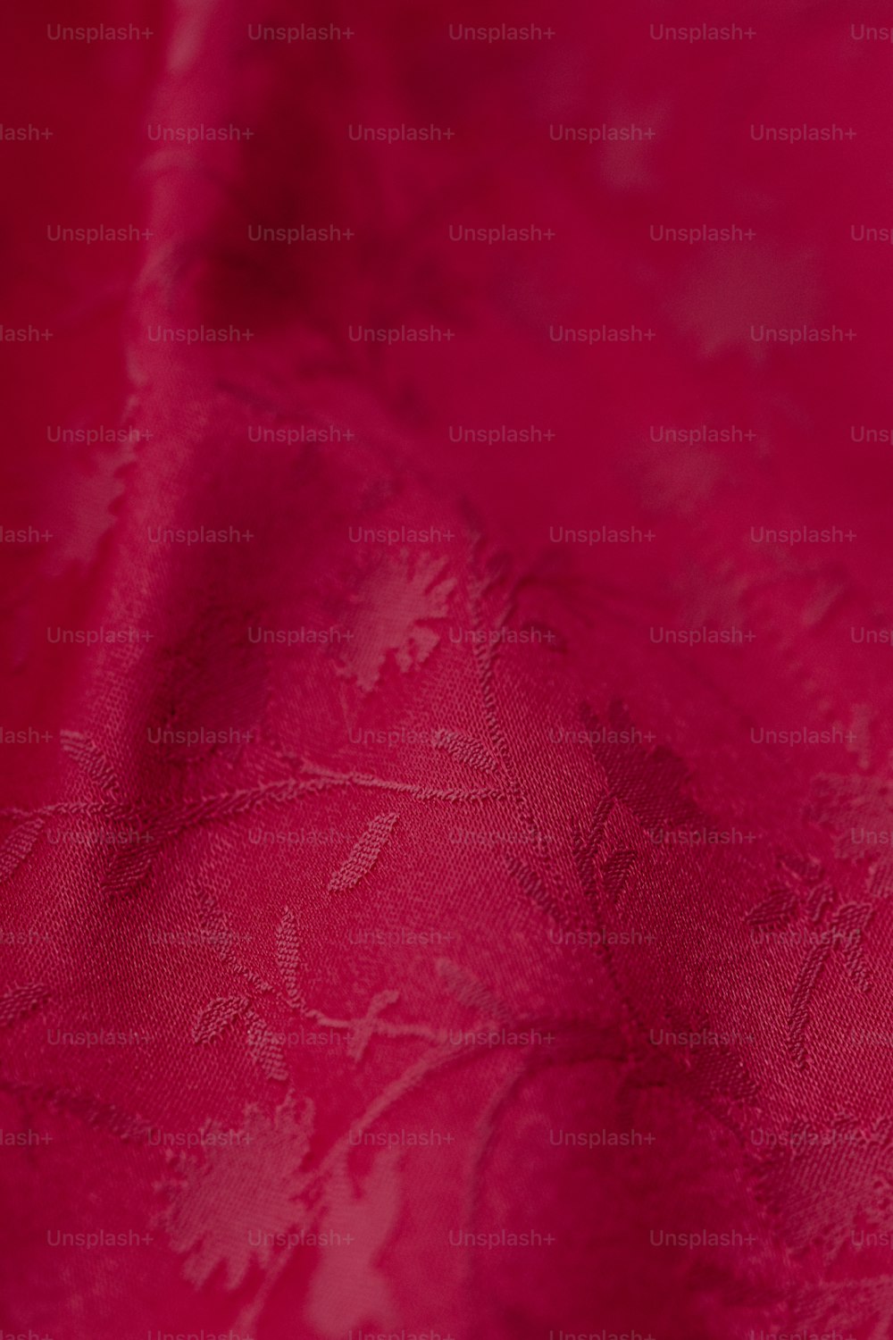 a close up of a red cloth with a flower pattern