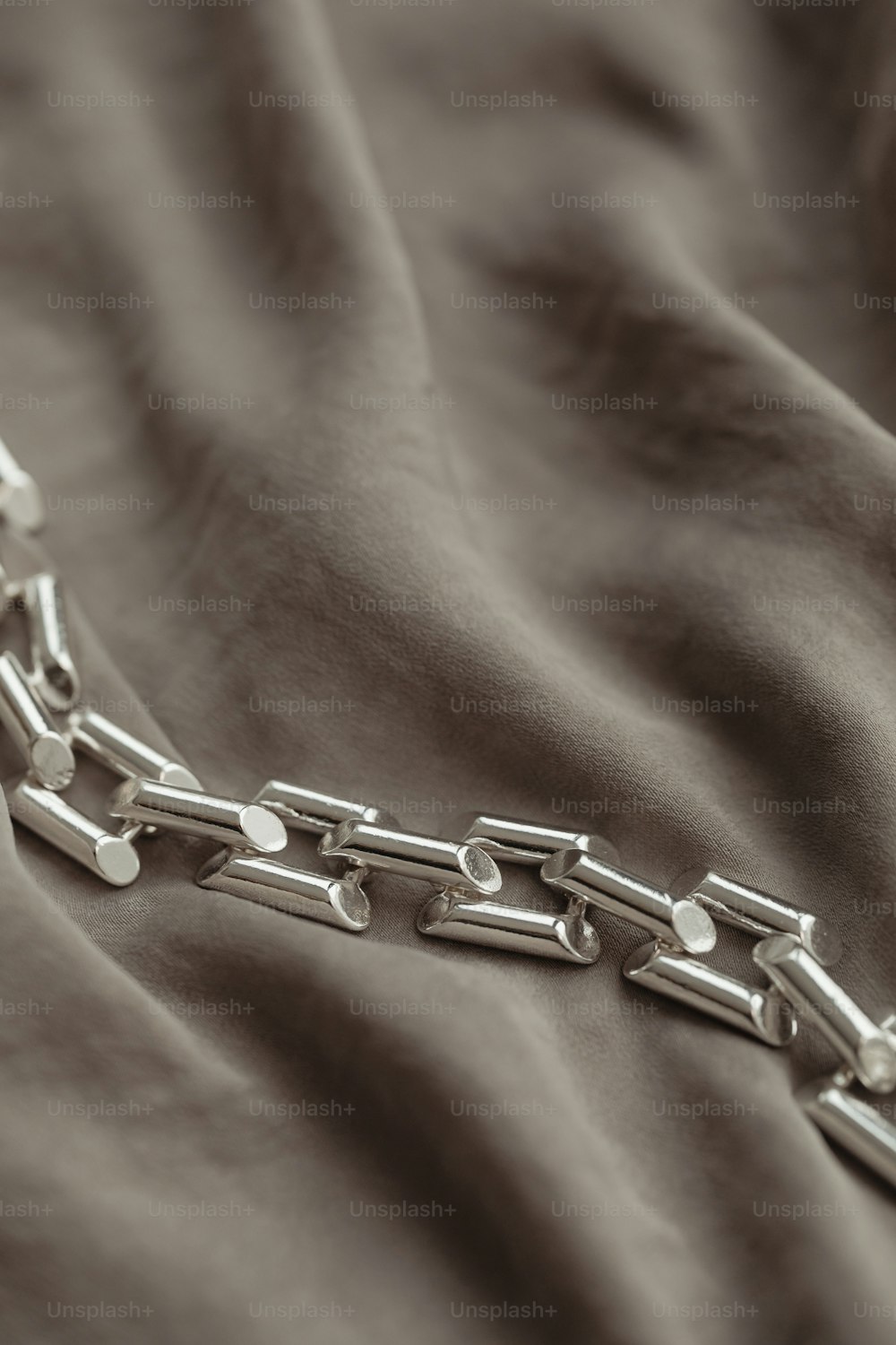 a close up of a chain on a bed