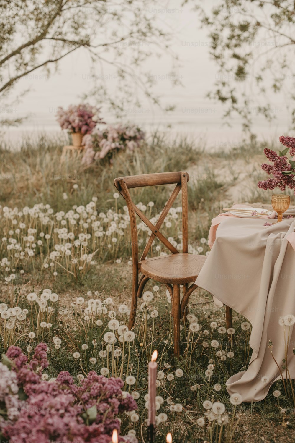 a table set for two in a field of flowers