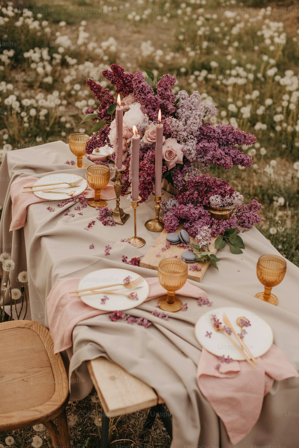 a table is set with plates, candles, and flowers