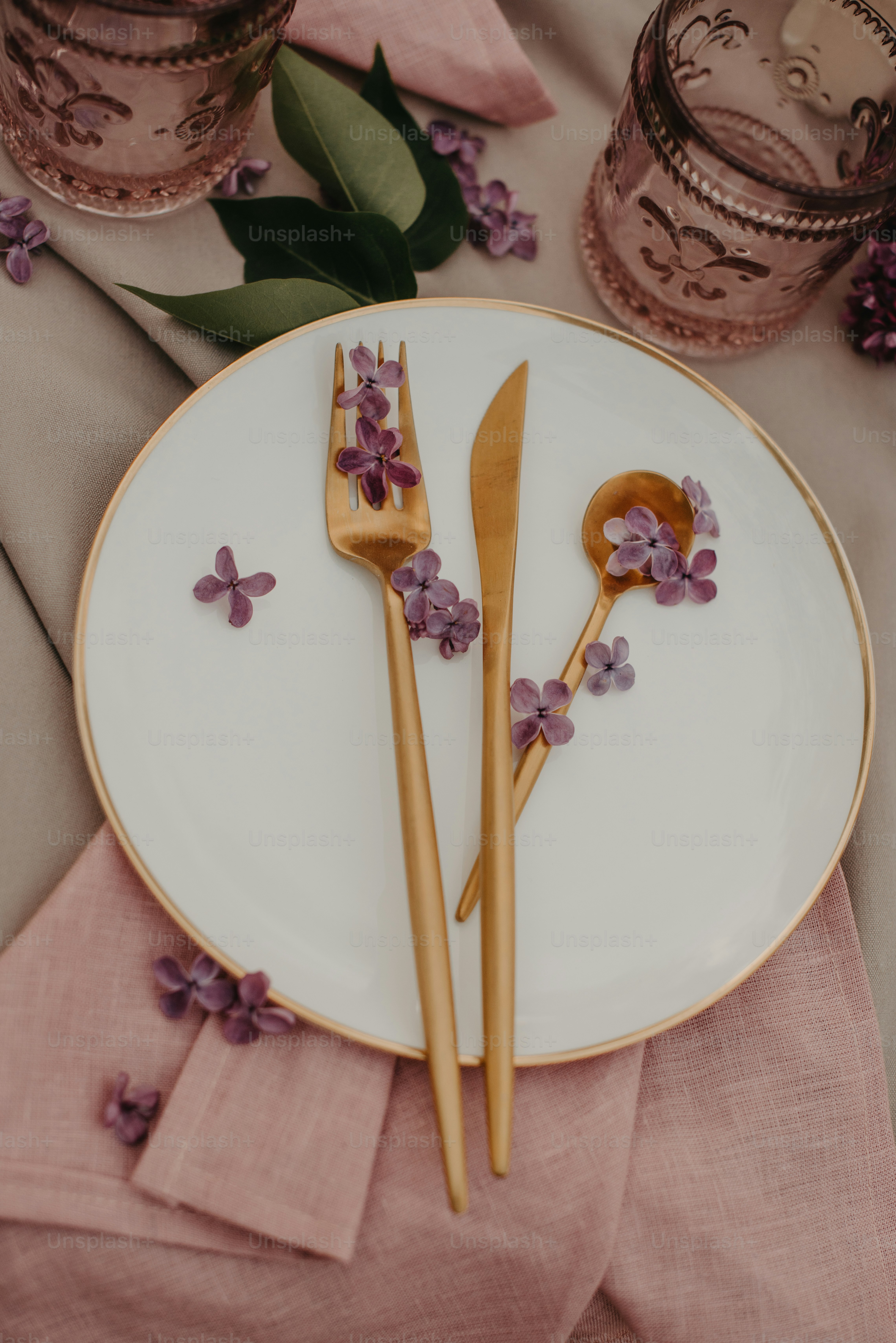 a white plate topped with two wooden utensils