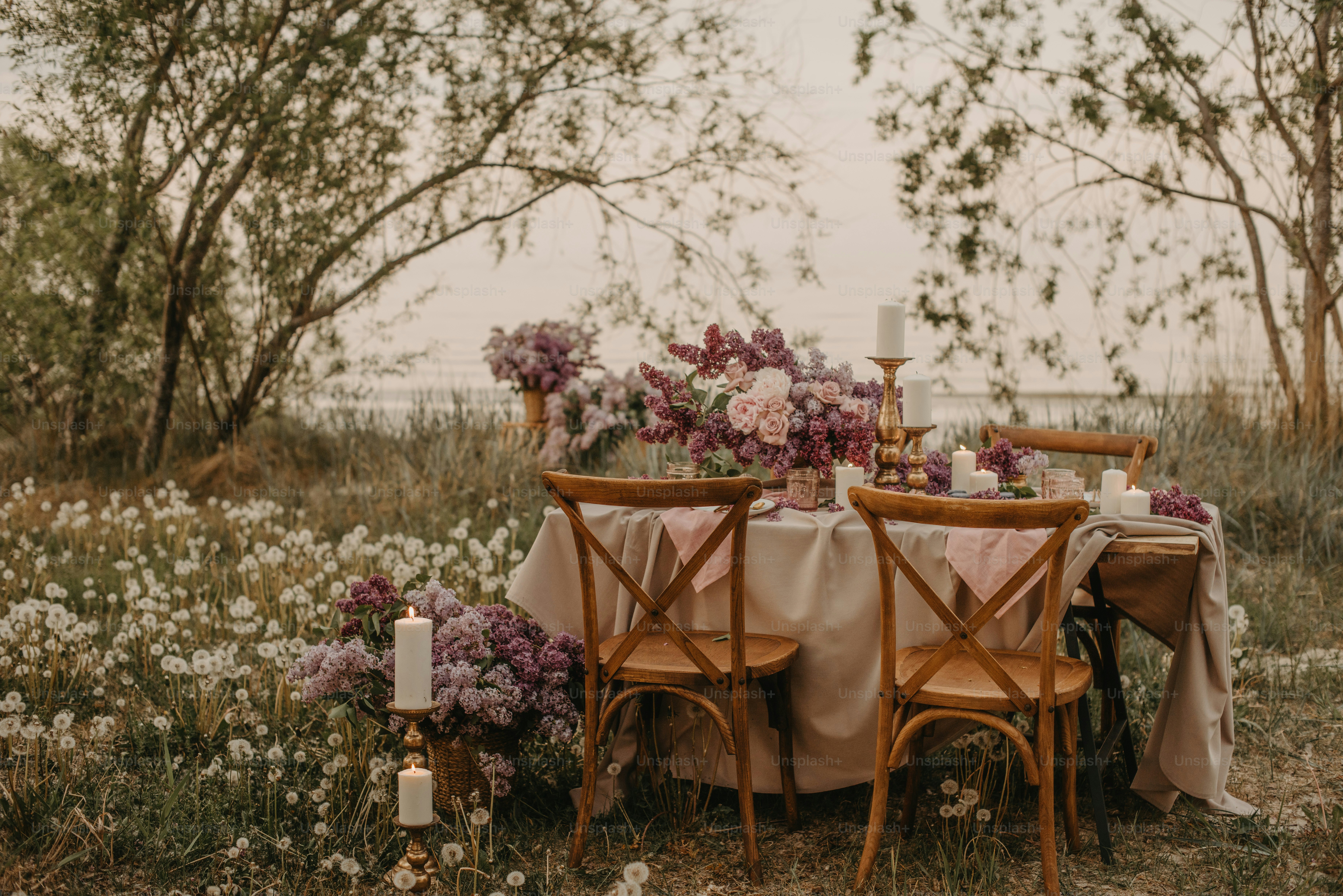 a table set up with flowers and candles