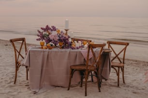 a table set up on the beach for a dinner