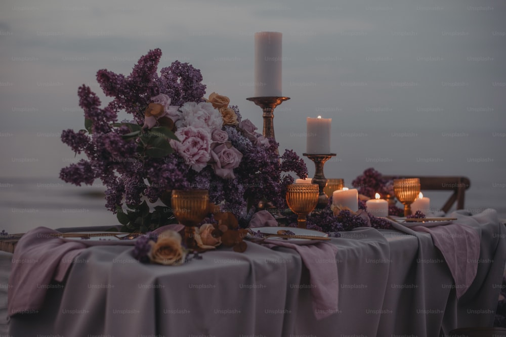 a table with candles and flowers on it