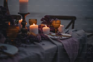a table topped with candles and plates of food