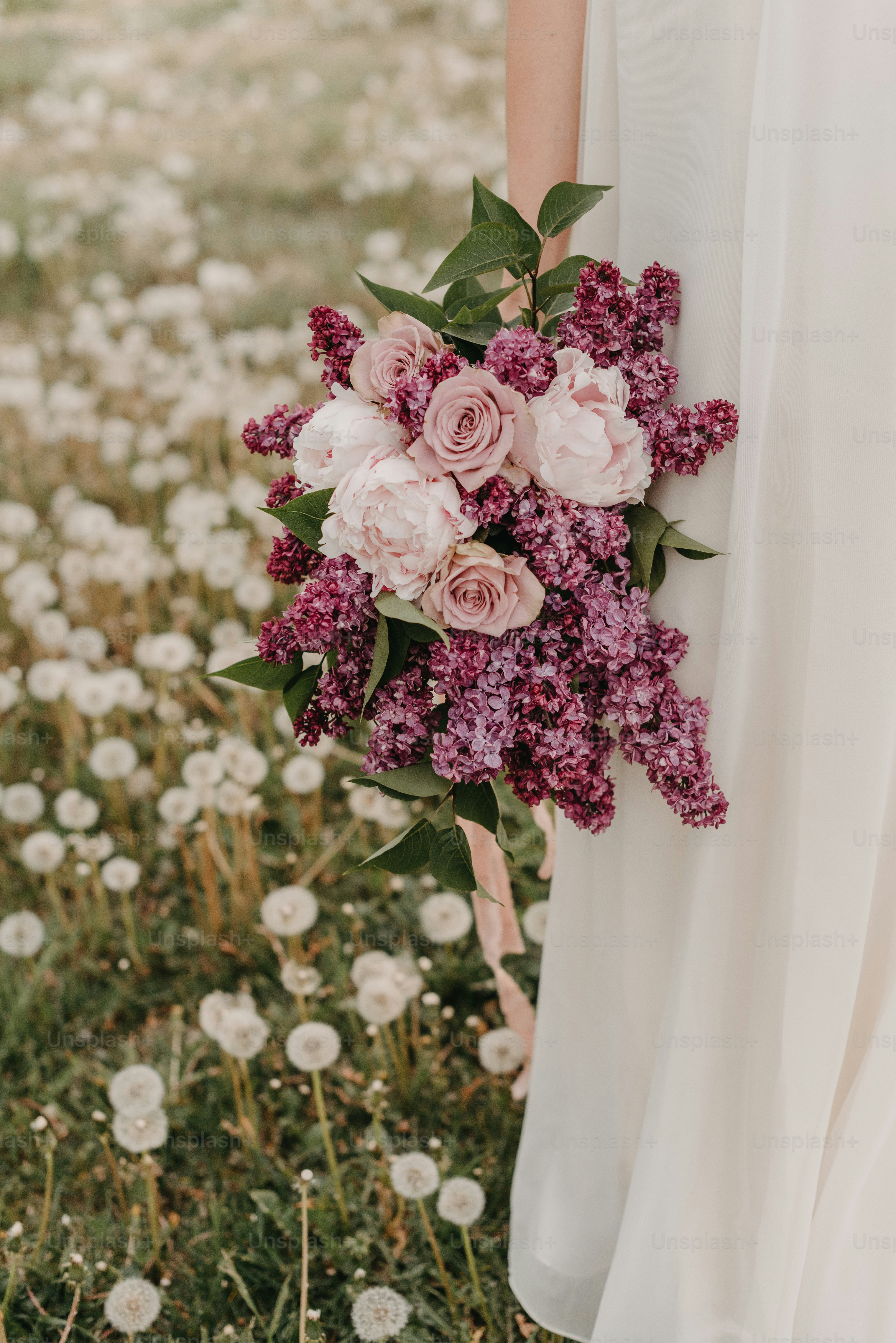 a woman in a white dress holding a bouquet of flowers