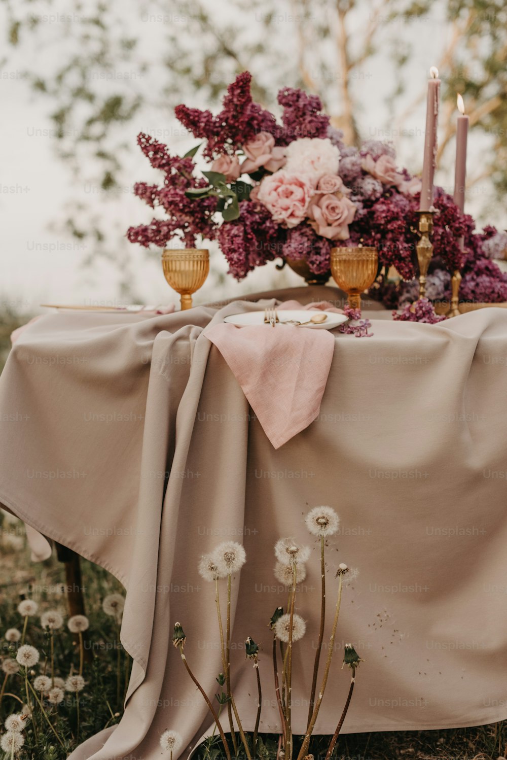 a table with flowers and candles on it