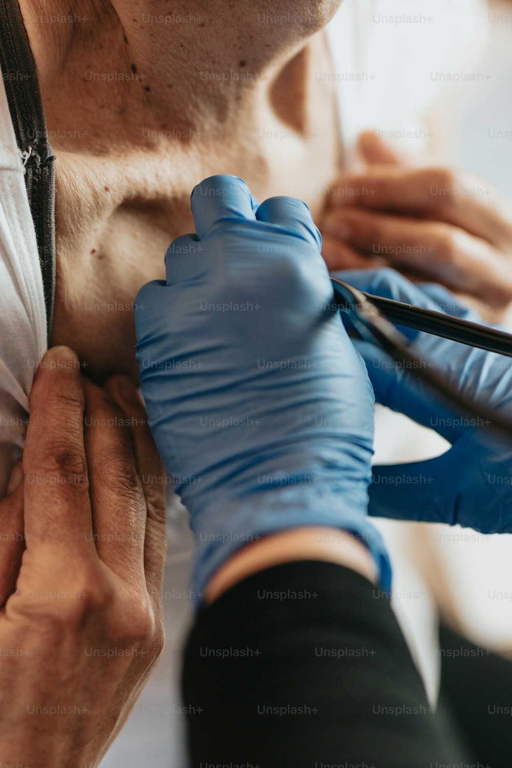 a person cutting a mans chest with scissors