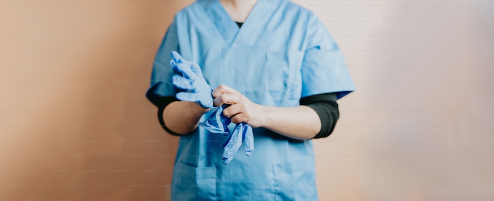 a person in scrubs holding a blue cloth