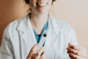 a woman in a white lab coat holding a sys