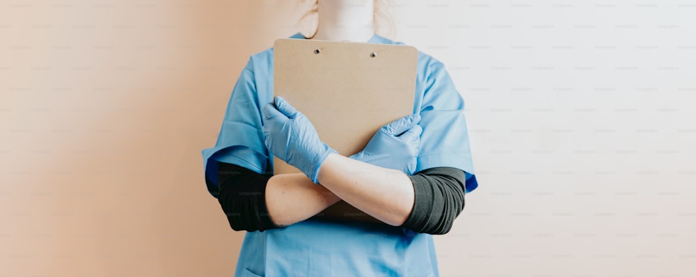 a person with a cast on their arm holding a piece of cardboard