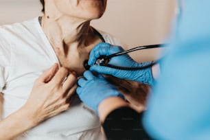 a woman getting her chest examined by a doctor
