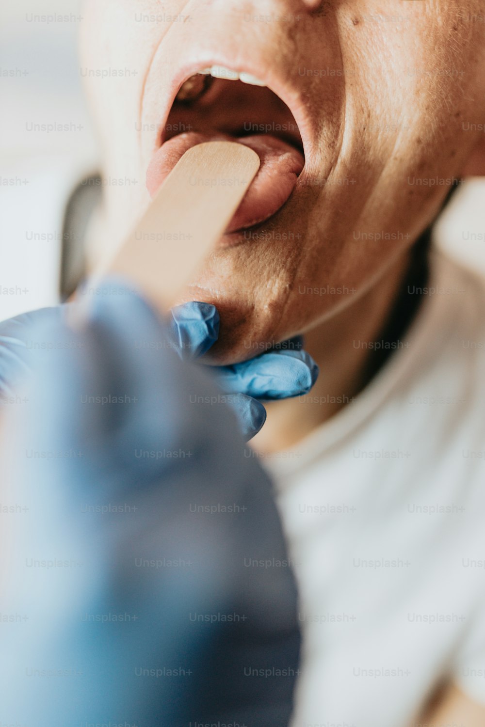a person with gloves and gloves on brushing their teeth