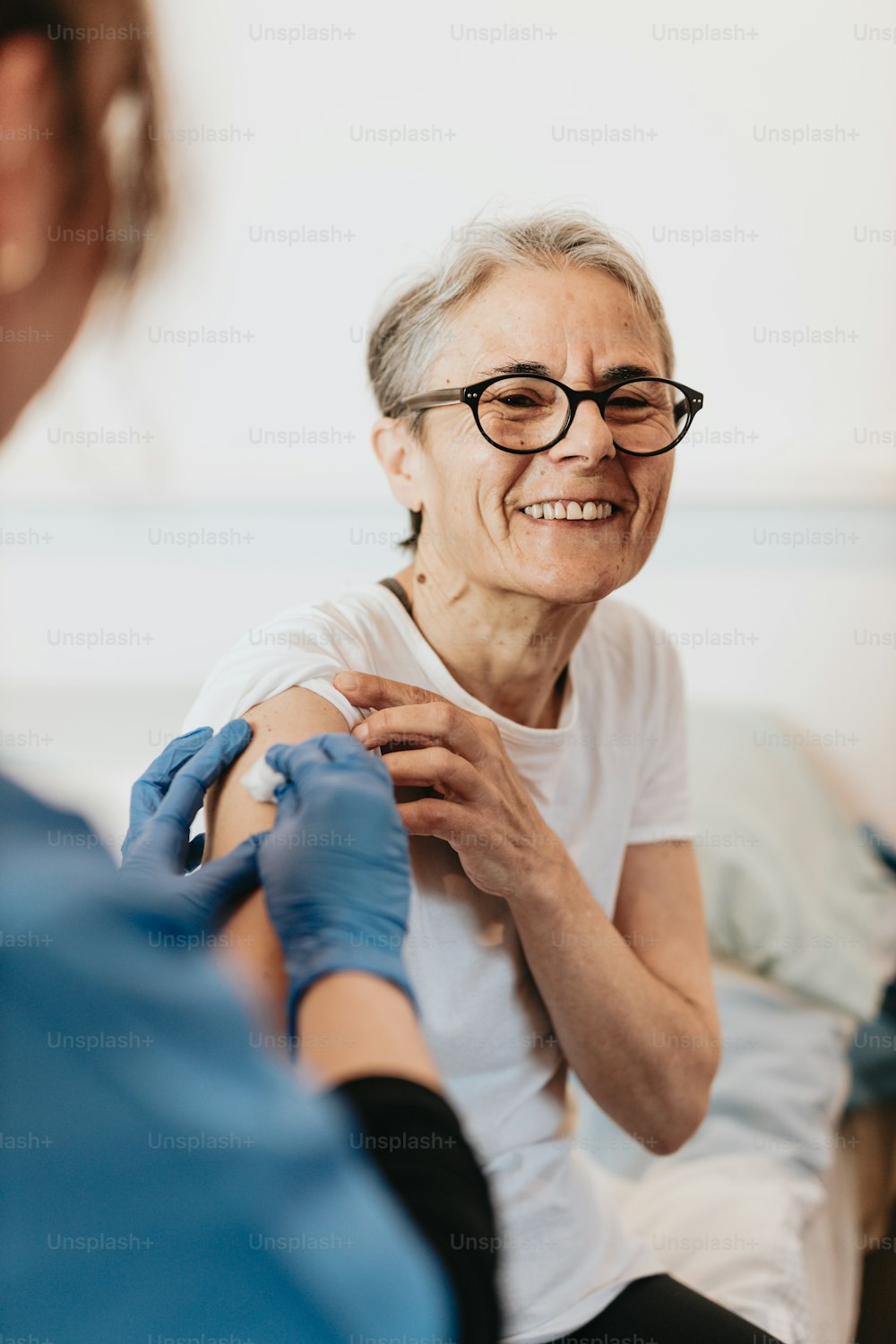 a woman getting her arm examined by a doctor