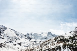 a mountain covered in snow with a sky background