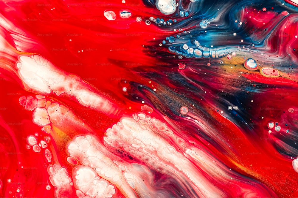 Un primo piano di un dipinto fluido rosso e blu