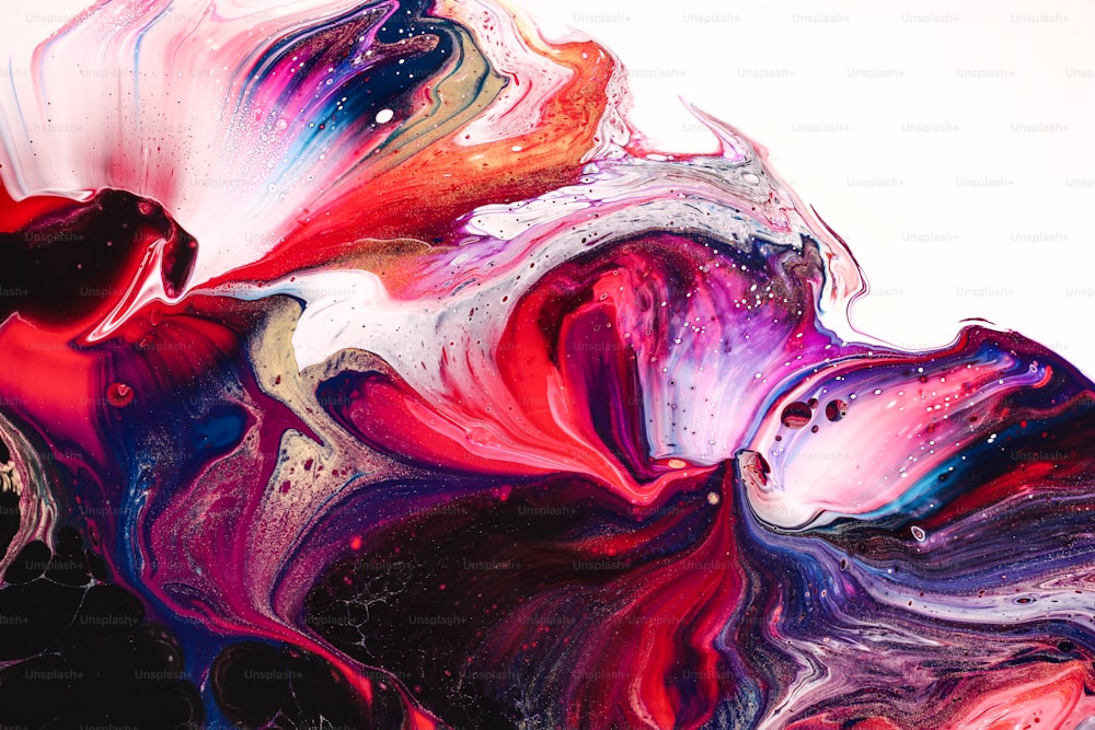 a close up of a colorful liquid painting on a white background
