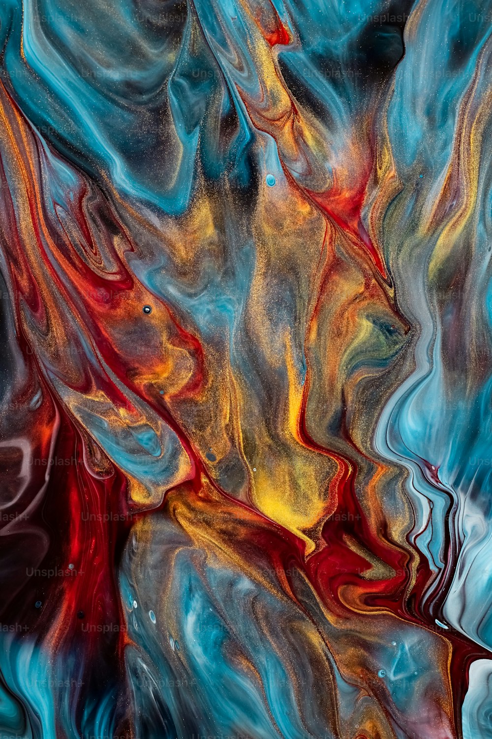 an abstract painting of blue, red, and yellow colors