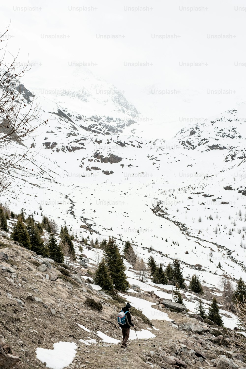 a person hiking up a snowy mountain with a backpack