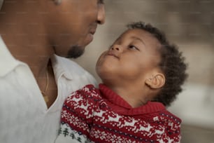 a man holding a small child in his arms