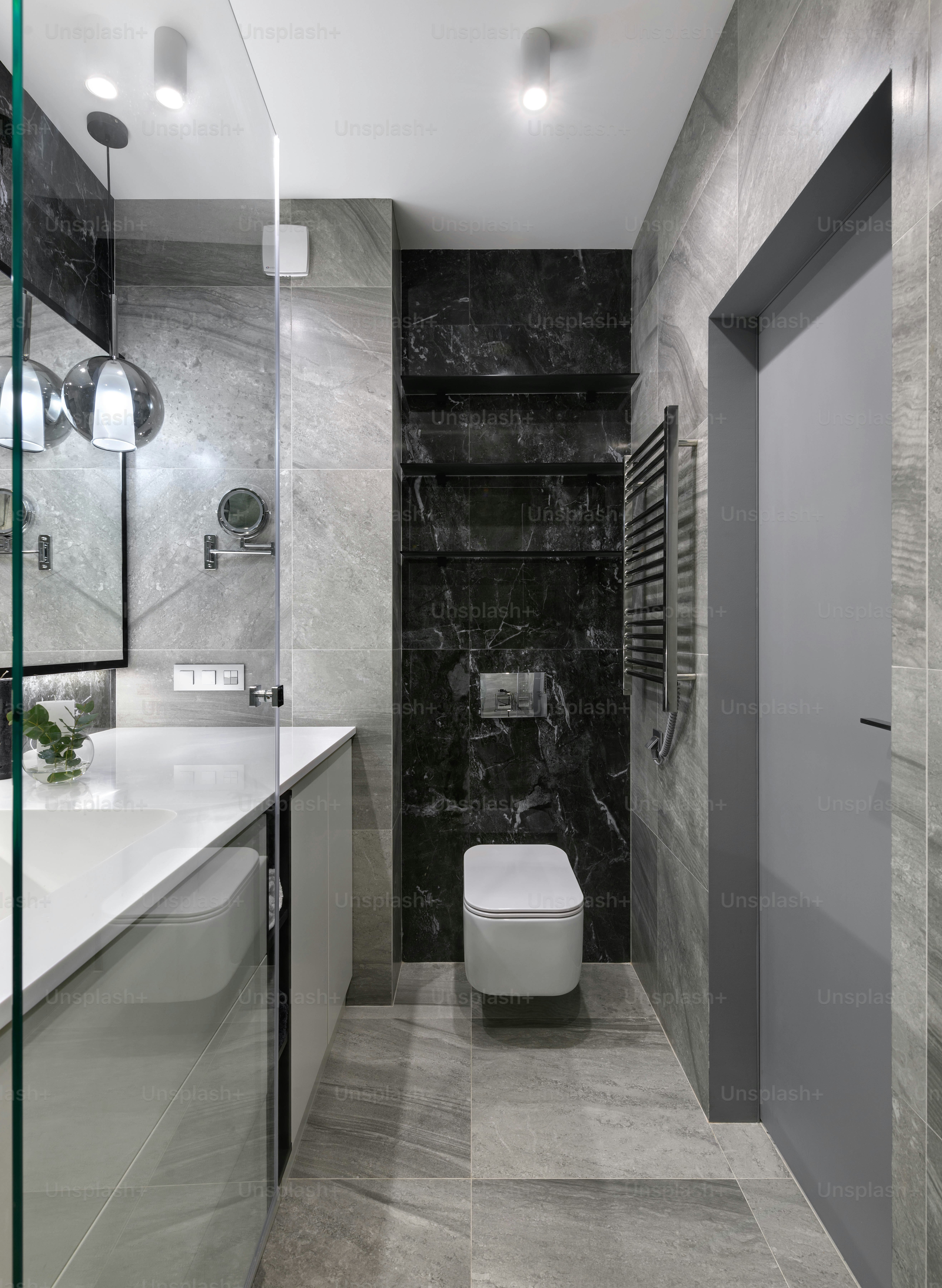 a bathroom with a toilet, sink, and mirror