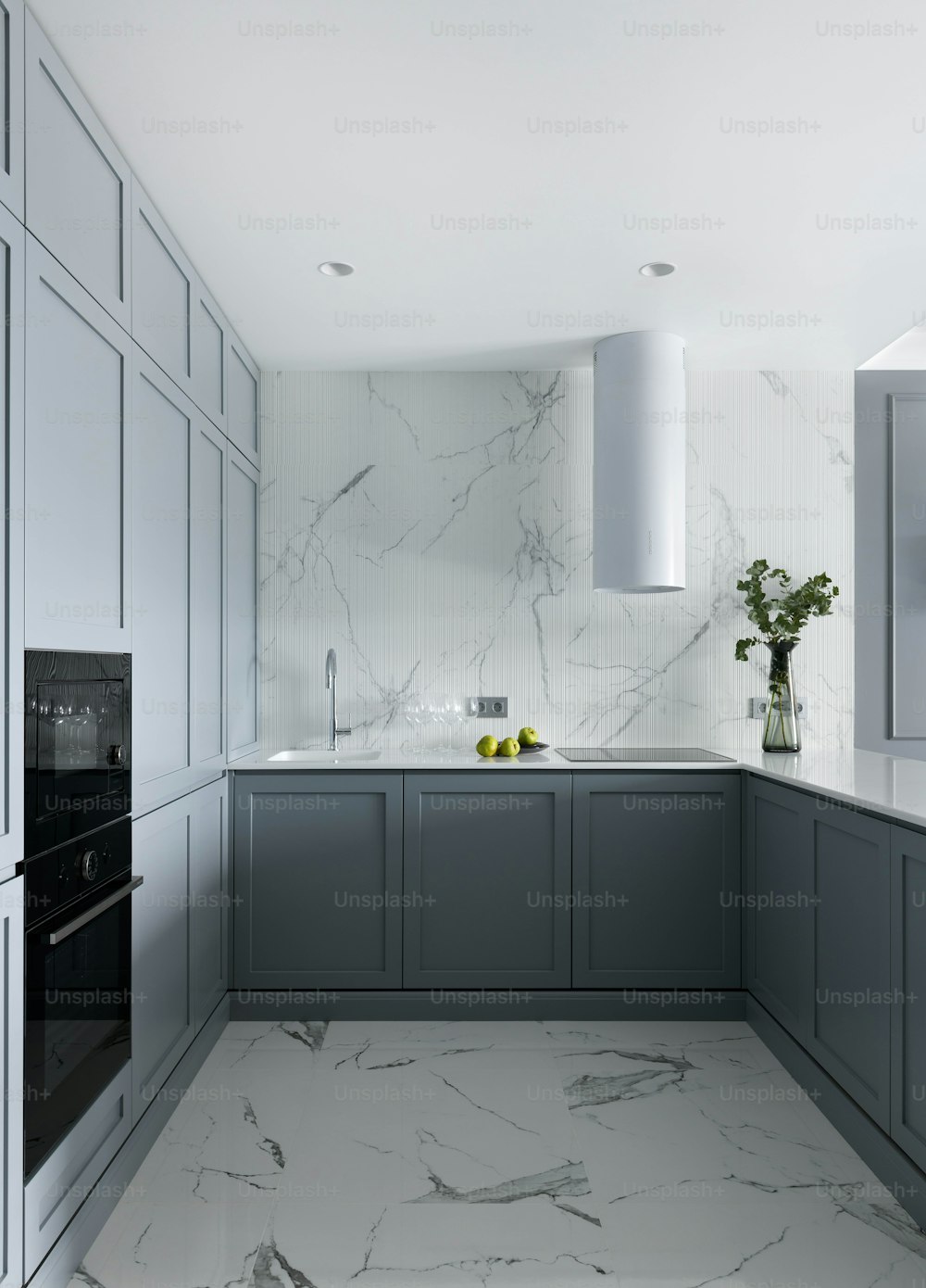 a kitchen with marble counter tops and gray cabinets