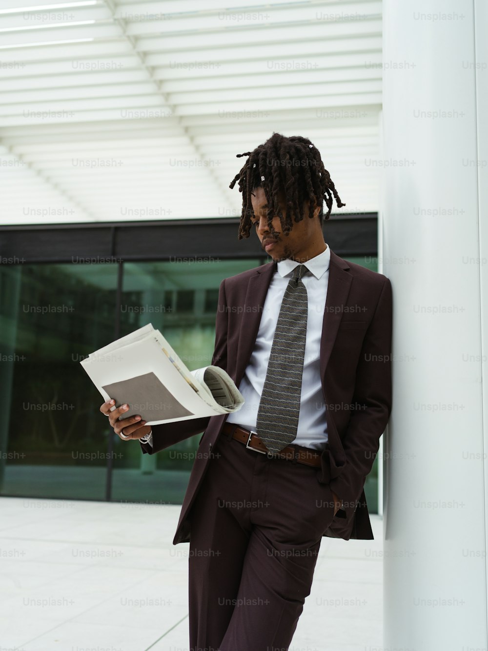 a man in a suit reading a book