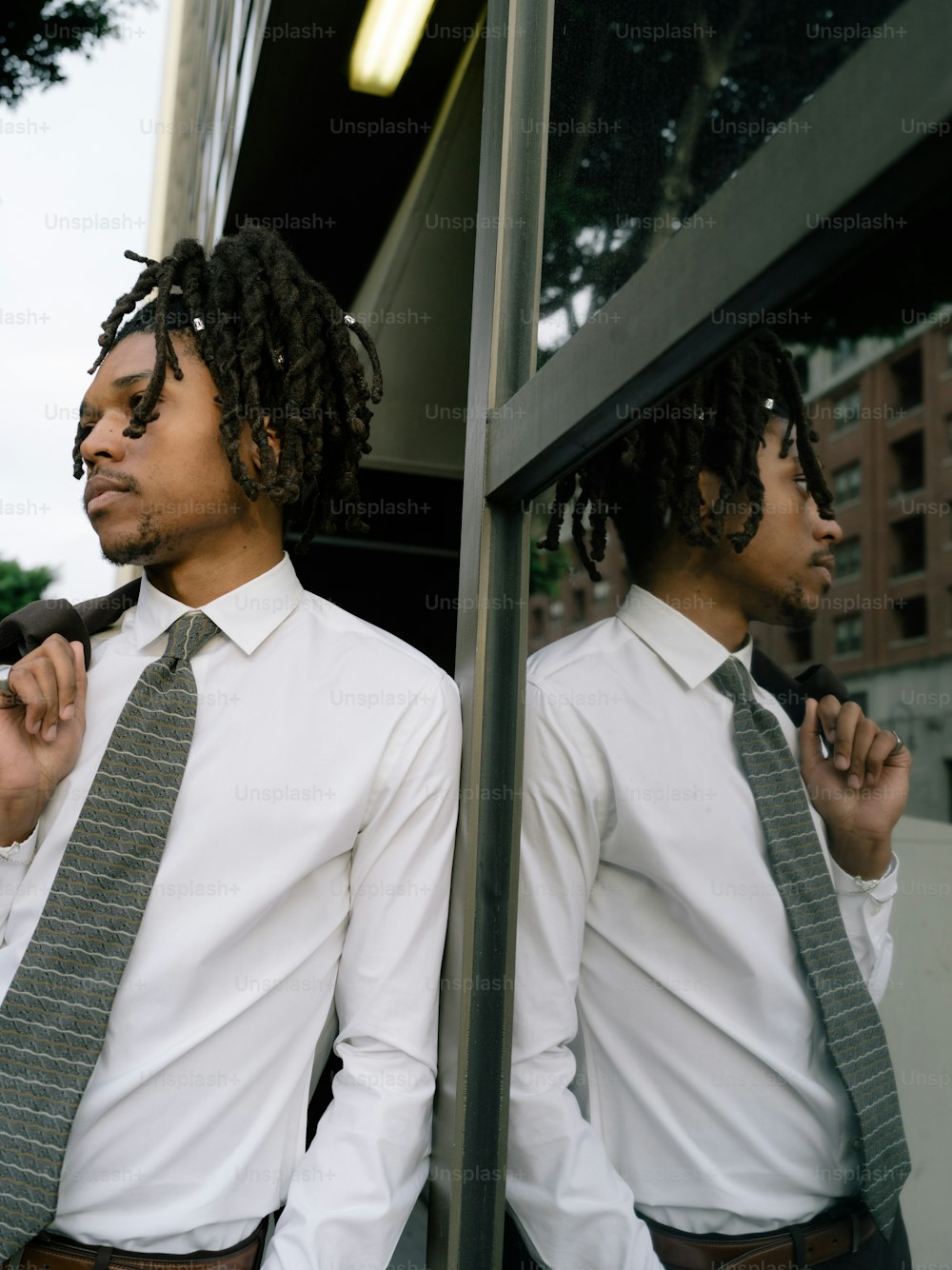 a man with dreadlocks and a tie