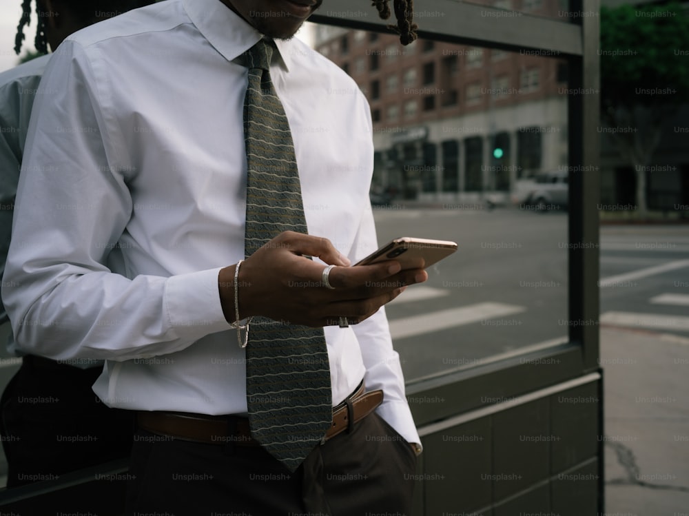 a man wearing a tie and using a cell phone