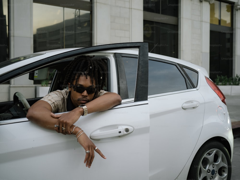 a man leaning out of a car window