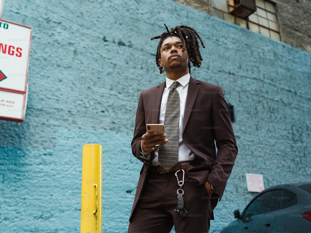 a man in a suit and tie holding a cell phone